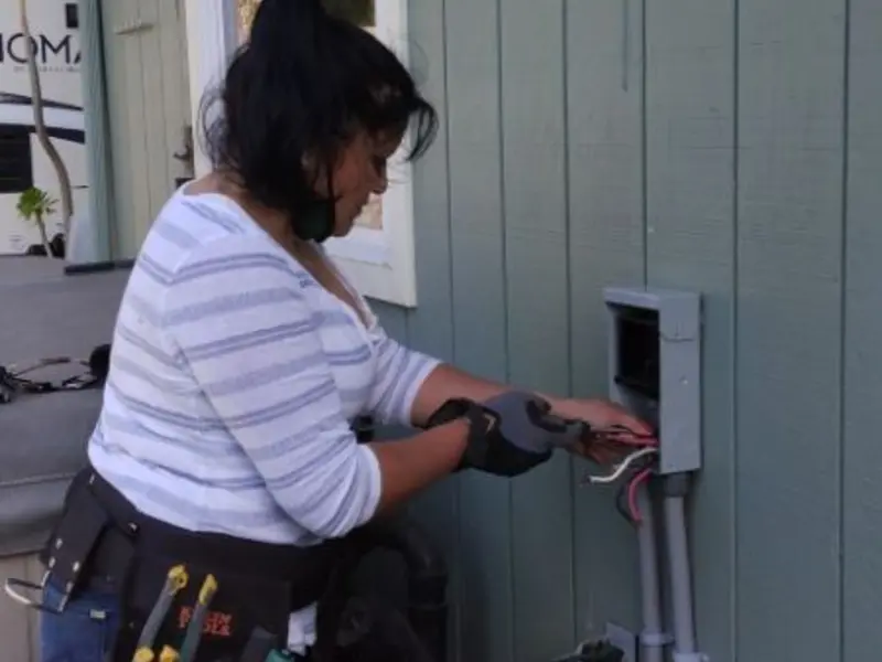 Licensed electrician wiring an exterior subpanel in Sweetwater